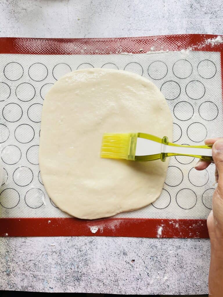 Brush the dough with oil