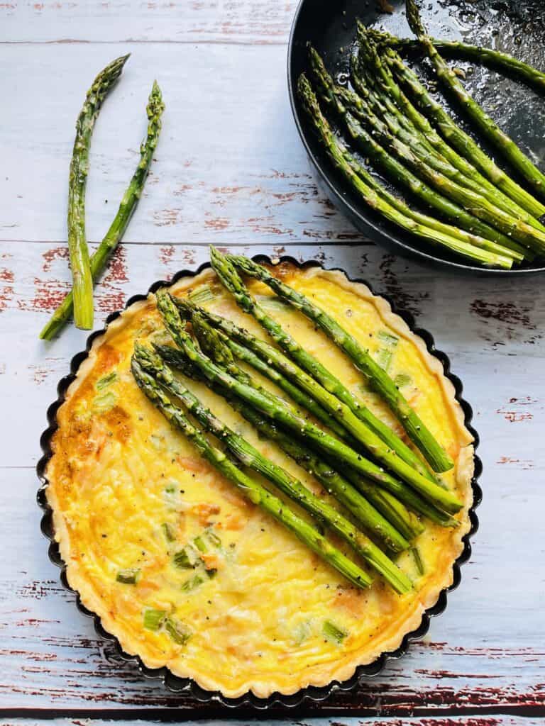 Quiche topped with roasted asparagus